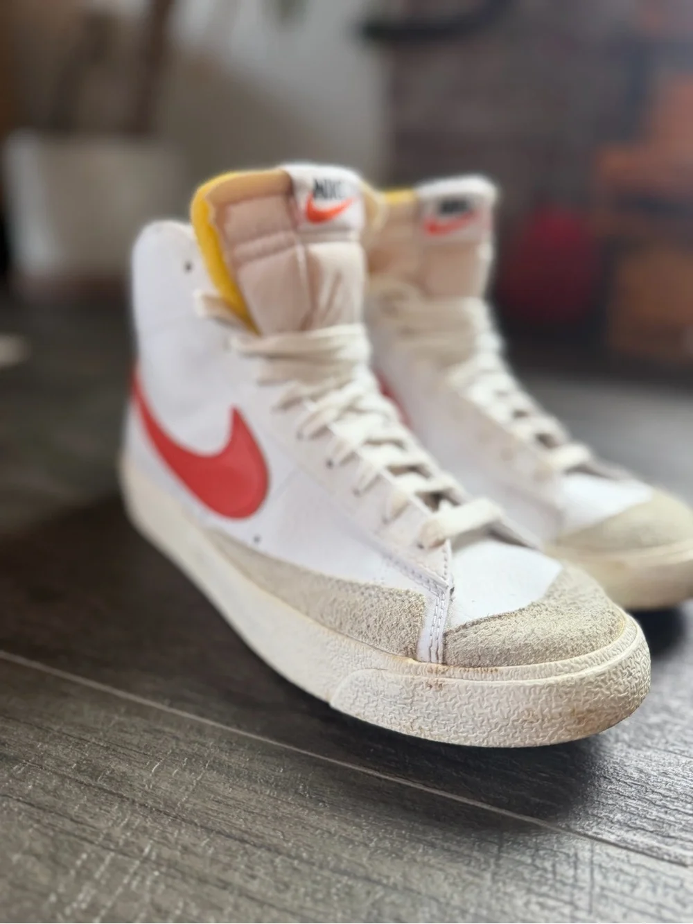 Nike Woman’s White High-Top Sneakers with Red Swoosh